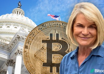 Senator Lummis in front of the Capitol building with a bitcoin behind her