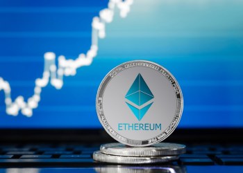 Picture of an ethereum coin with a chart behind it