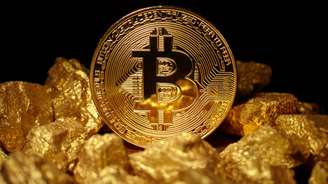 Picture of bitcoin on top of gold blocks
