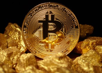Picture of bitcoin on top of gold blocks