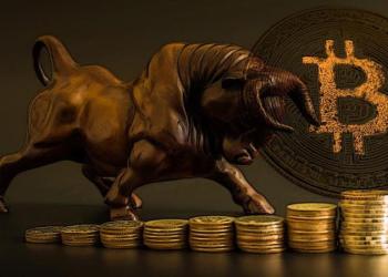 Picture of a bronze colored bull with bitcoins all around it, representing bitcoin bullish price as Amazon rumors circulate