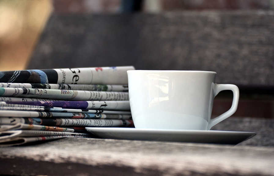 Slate, newspapers and a cup