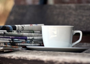 Slate, newspapers and a cup