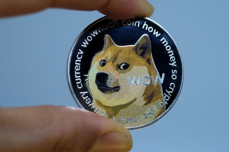Picture of a hand holding a dogecoin, as elon musk confirms holding bitcoin and ethereum also