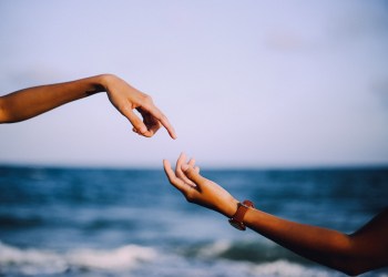 Bitcoin Law, two hands almost touching