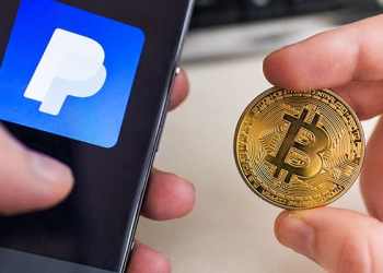 Picture of two hands with a mobile phone that says PayPal in one and a bitcoin crypto coin in the other