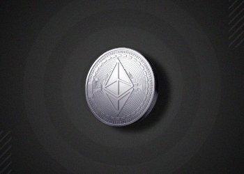 Picture of a silver Ethereum coin on a black background