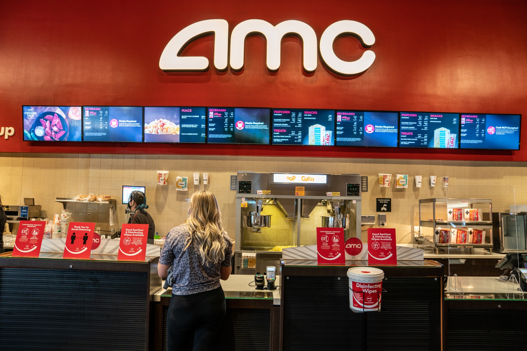 Picture of people standing at the concession stand of an AMC theater
