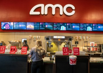 Picture of people standing at the concession stand of an AMC theater