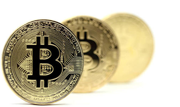 Picture of three bitcoins standing in a row