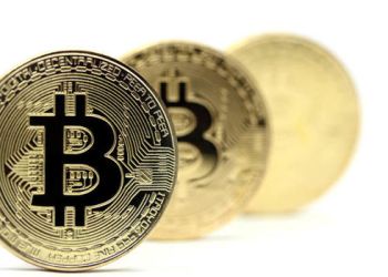 Picture of three bitcoins standing in a row