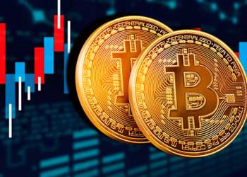 Picture of two bitcoins in front of a red and blue candlestick chart