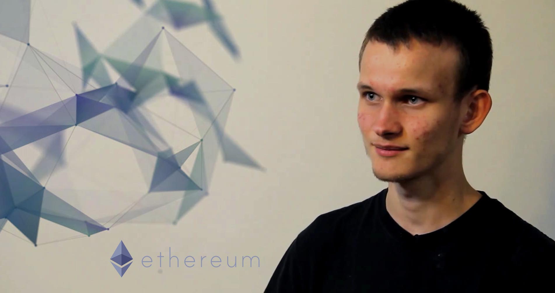 Picture of Ethereum founder Vitalik Buterin with Ethereum's logo next to him