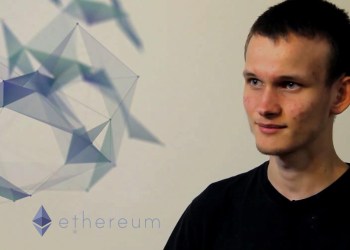 Picture of Ethereum founder Vitalik Buterin with Ethereum's logo next to him