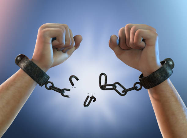 Picture of two hands with a broken chain on both wrists, depicting freedom from chains