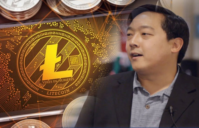 Picture of Litecoin creator Charlie Lee with a gold Litecoin next to him
