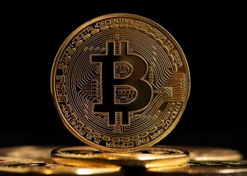 Picture of a Bitcoin standing on top of staked coins