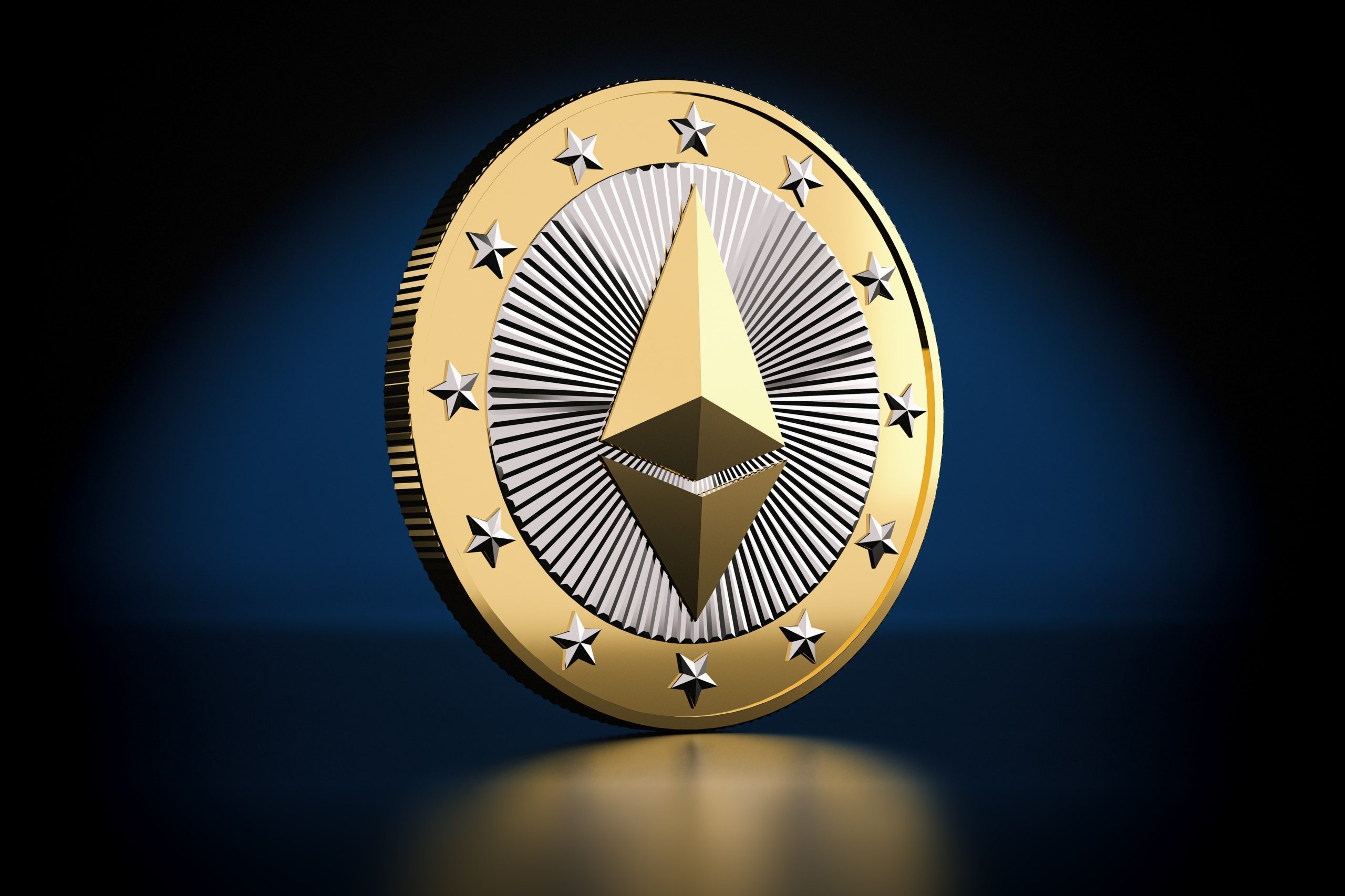 Picture of a gold and silver Ethereum coin standing on a dark blue background