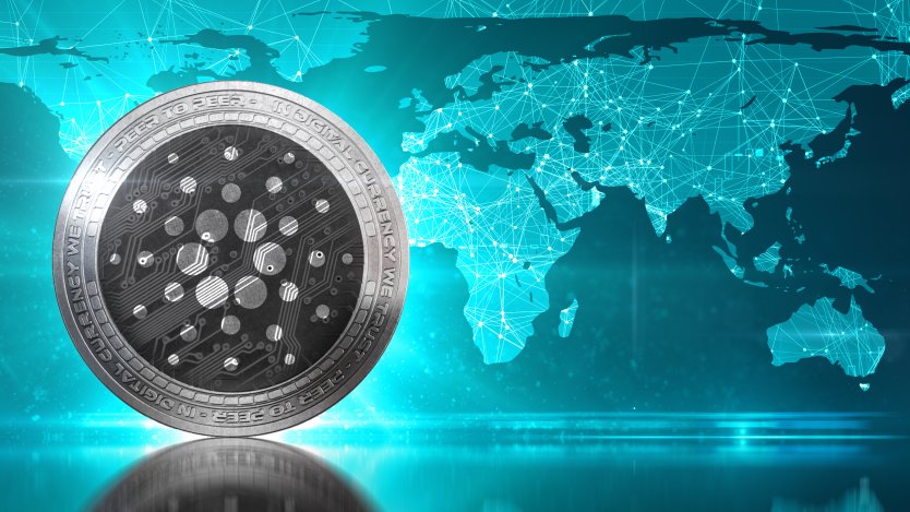 Picture of a Cardano coin in front of a map of the world