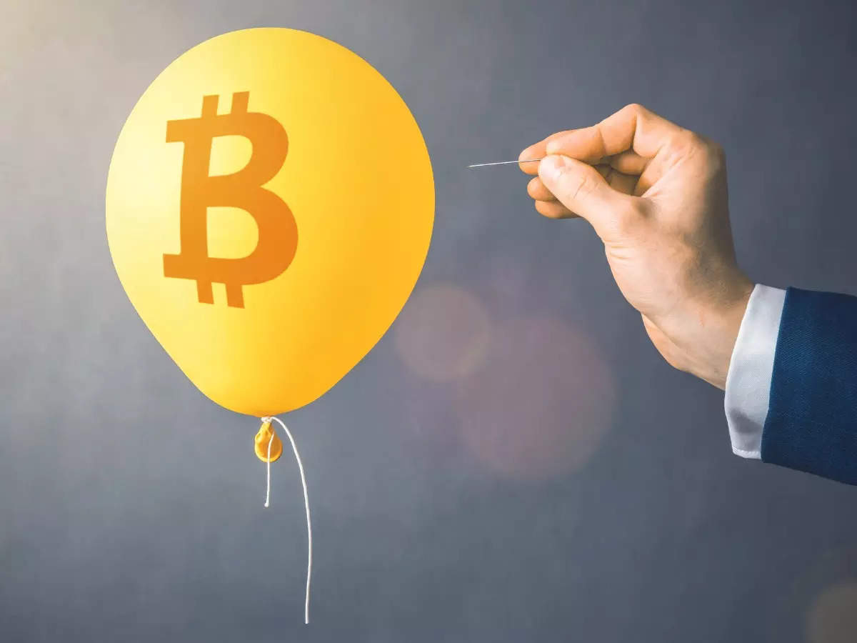 Picture of a hand with a needle about to prick a balloon with bitcoin logo on it, representing the BitConnect scam
