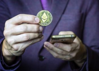 Hand holding an Ethereum coin