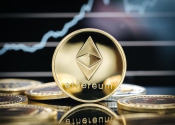 Picture of an Ethereum coin standing on top other coins