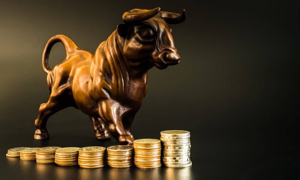 Picture of a bull standing on gold coins