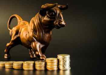 Picture of a bull standing on gold coins