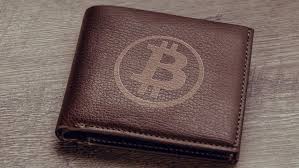 Picture of a brown wallet with a bitcoin logo on it
