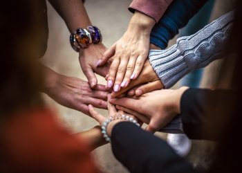 Bitcoin for Communities, hands doing the "all for one "