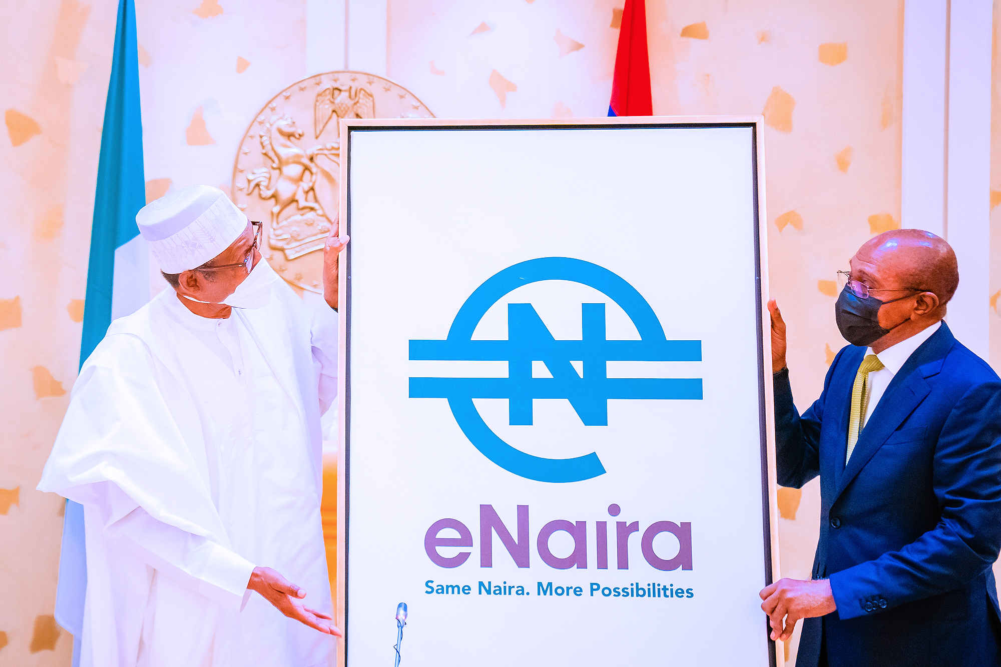 Nigerian president holding a picture with eNaira on it