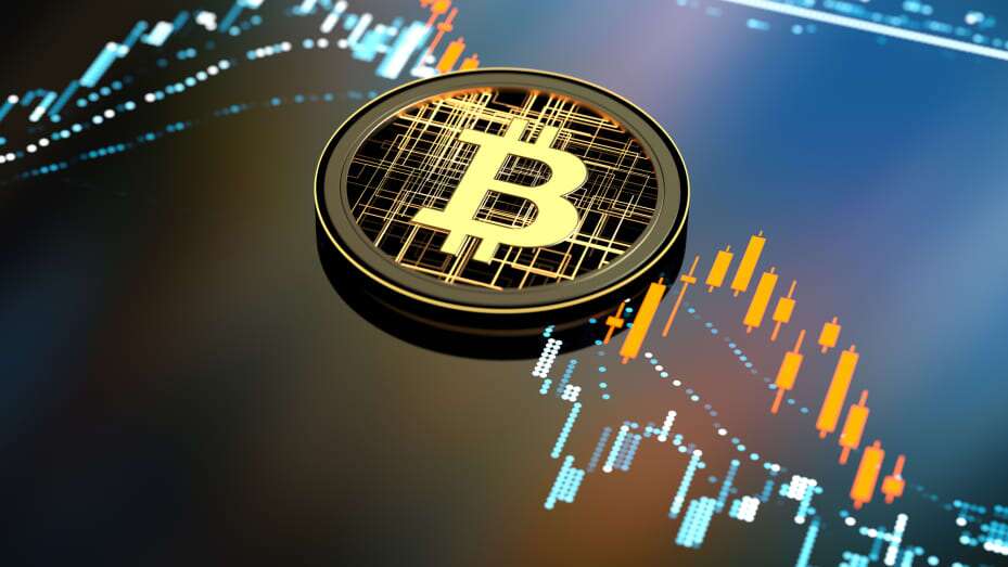 Bitcoin laying on a market chart