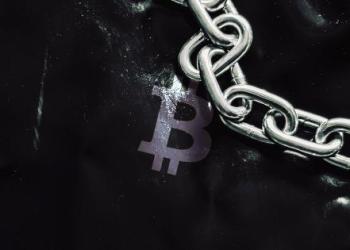 Bitcoin with chain next to it