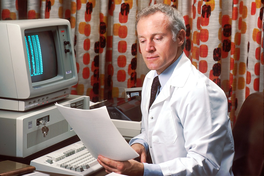 Unchained Capital, a doctor in front of a computer in the eighties