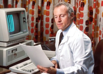 Unchained Capital, a doctor in front of a computer in the eighties
