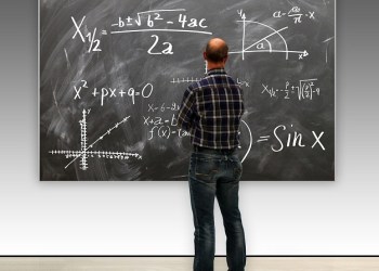 Harvard Professor in front of a blackboard