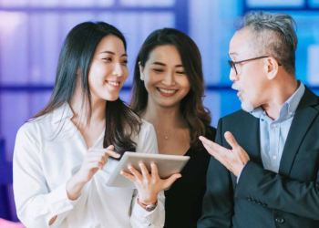 Singapore, two asian woman and a man in work attire