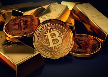 Bitcoin and gold bars - Three bitcoins lying together with ingot