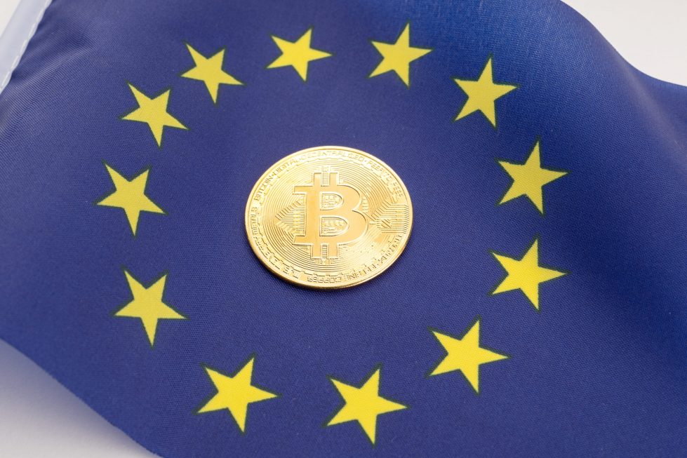 Bitcoin coin on European Union flag. Cryptocurrency on Europe